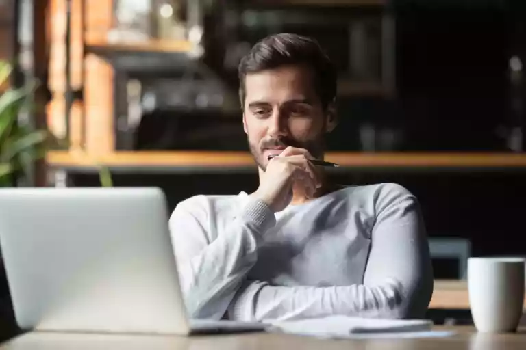 Man thinking with laptop